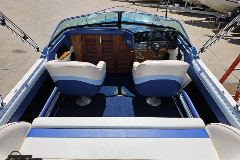 Slide: The Image of 1988 Glastron/Carlson CVX-23 boat interior with blue and white seating and dashboard. - 39