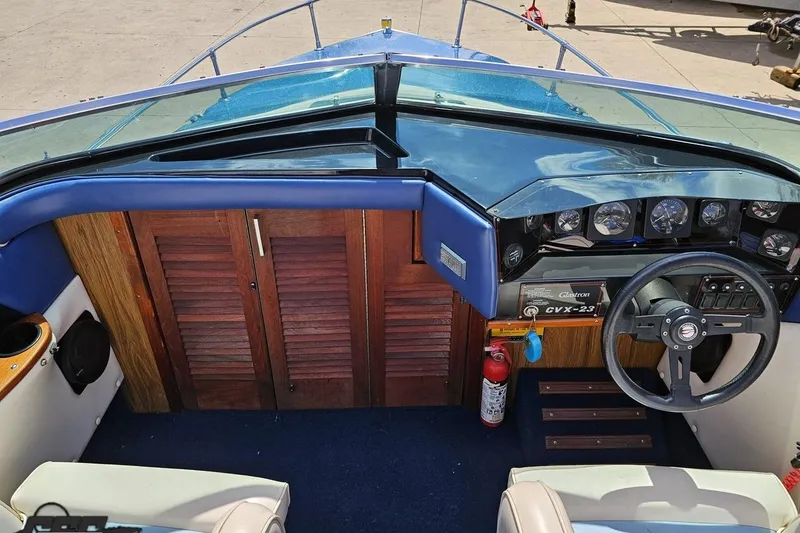 Slide: The Image of 1988 Glastron/Carlson CVX-23 boat dashboard with steering wheel and gauges. - 46