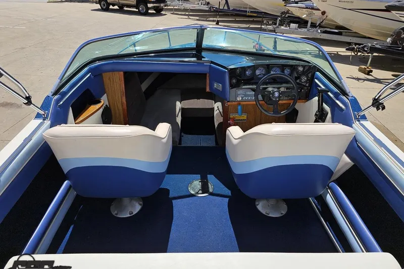 Slide: The Image of 1988 Glastron/Carlson CVX-23 boat interior with blue and white seating and dashboard. - 49