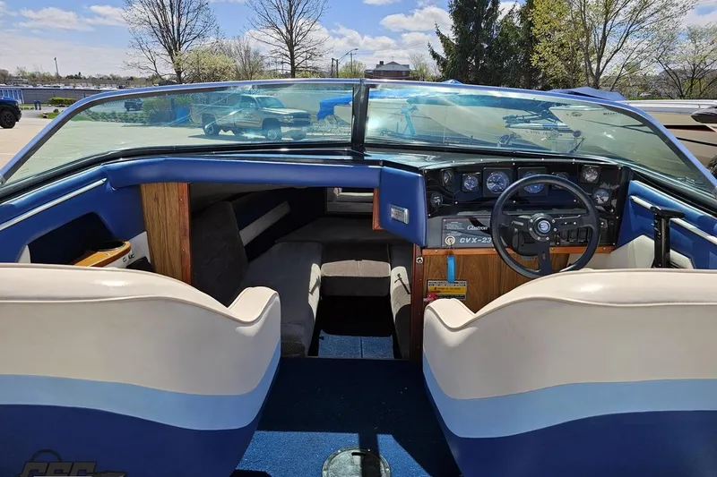 Slide: The Image of 1988 Glastron/Carlson CVX-23 boat interior with blue and white seating, dashboard, and steering wheel. - 50