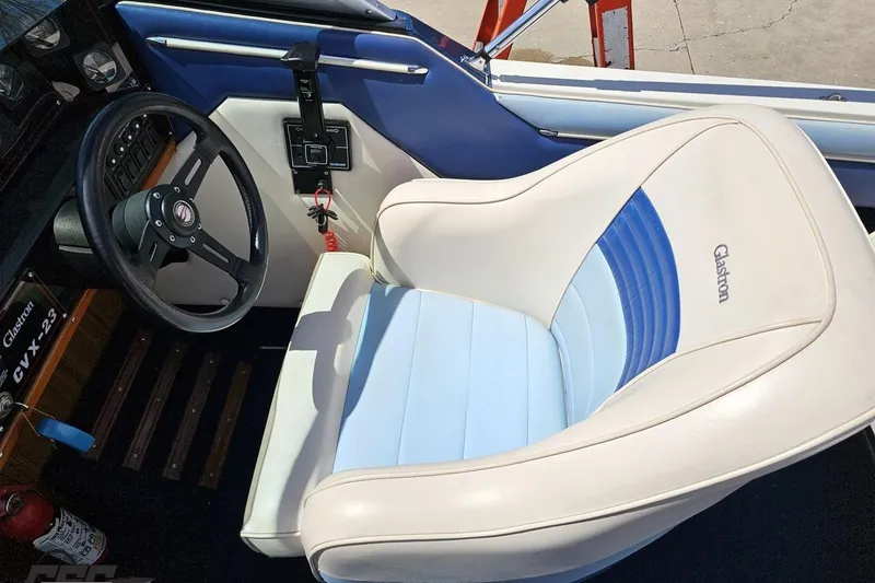 Slide: The Image of 1988 Glastron/Carlson CVX-23 boat interior with steering wheel and cushioned seat. - 52