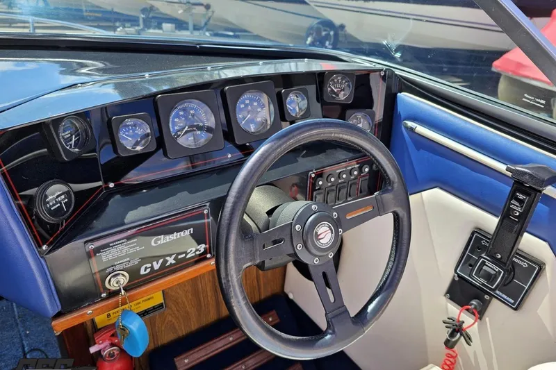 Slide: The Image of 1988 Glastron/Carlson CVX-23 boat dashboard with steering wheel and instrument panel. - 54