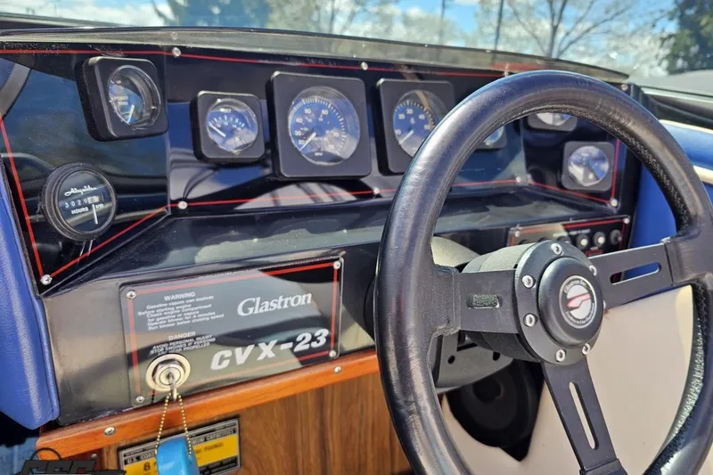 Slide: The Image of Dashboard of a 1988 Glastron/Carlson CVX-23 boat with steering wheel and gauges. - 55