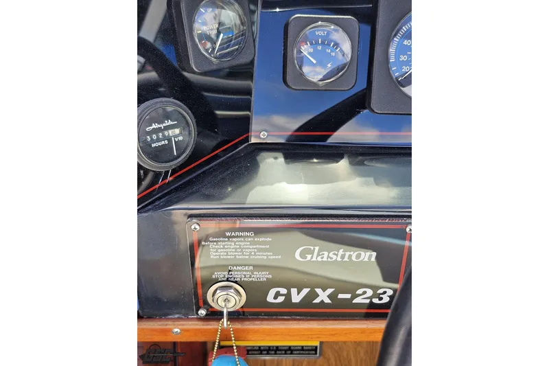 Slide: The Image of 1988 Glastron/Carlson CVX-23 dashboard with gauges and warning labels. - 56