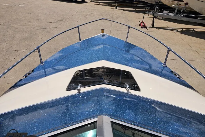 Slide: The Image of 1988 Glastron/Carlson CVX-23 boat with blue glitter finish, docked on concrete. - 59