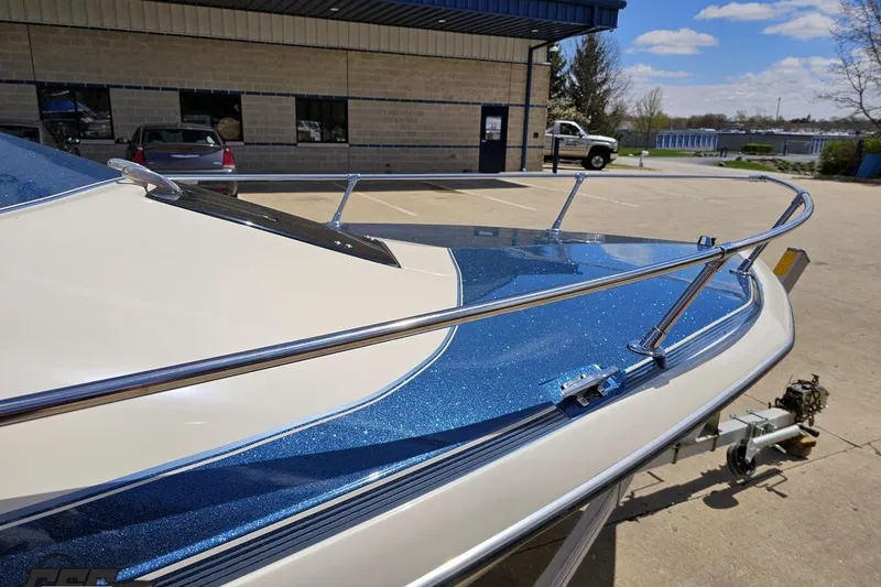 Slide: The Image of 1988 Glastron/Carlson CVX-23 boat with blue metallic finish, parked outdoors. - 6