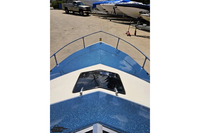 Slide: The Image of 1988 Glastron/Carlson CVX-23 boat with blue glitter finish, docked outdoors. - 60