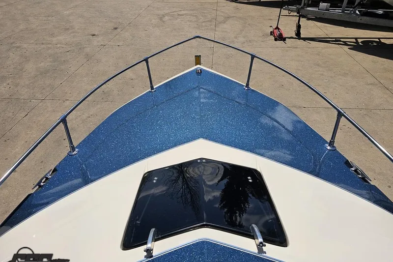 Slide: The Image of 1988 Glastron/Carlson CVX-23 boat bow with blue metallic finish and railing. - 61