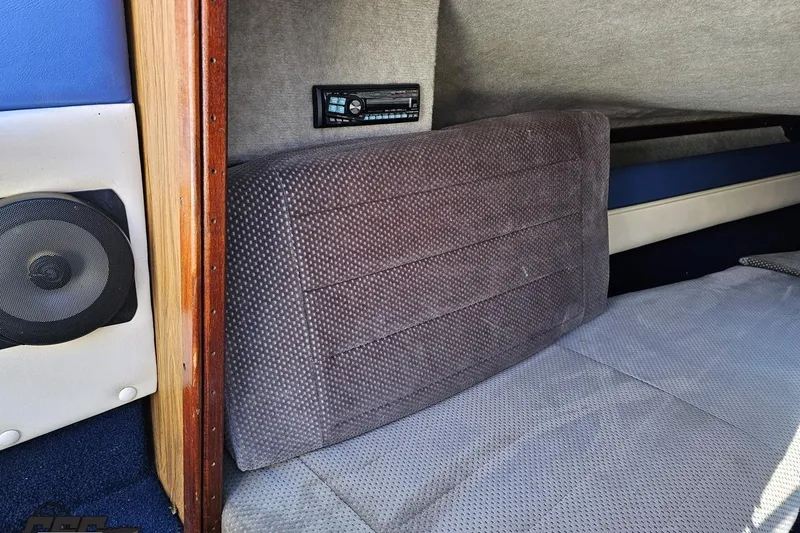 Slide: The Image of Interior of 1988 Glastron/Carlson CVX-23 boat with speaker and cushioned seating. - 63