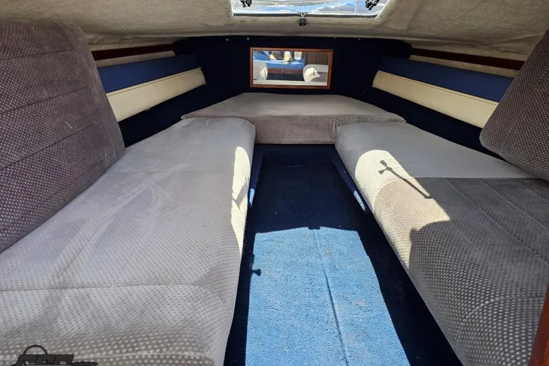 Slide: The Image of Interior cabin of 1988 Glastron/Carlson CVX-23 boat with cushioned seating. - 65