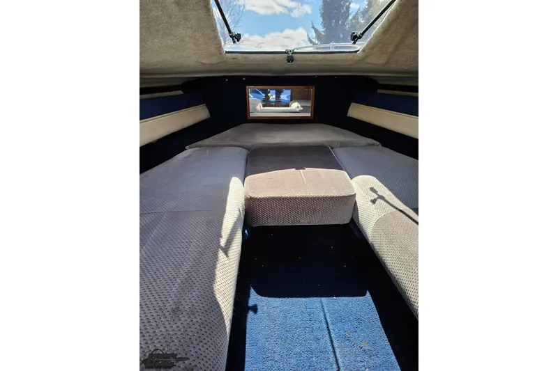 Slide: The Image of Interior cabin of 1988 Glastron/Carlson CVX-23 boat with cushioned seating and skylight. - 67