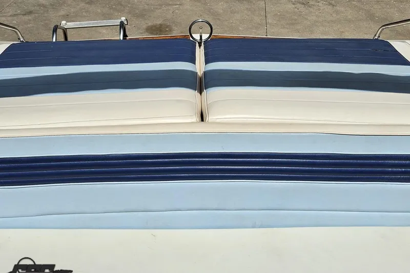 Slide: The Image of 1988 Glastron/Carlson CVX-23 boat seat with blue and white striped upholstery. - 75