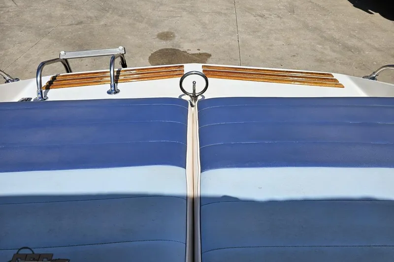 Slide: The Image of 1988 Glastron/Carlson CVX-23 boat with blue upholstery and wooden accents on deck. - 76