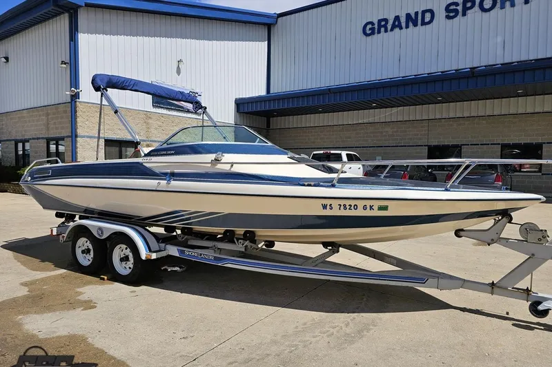 Slide: The Image of 1988 Glastron/Carlson CVX-23 boat on trailer outside Grand Sport dealership. - 8