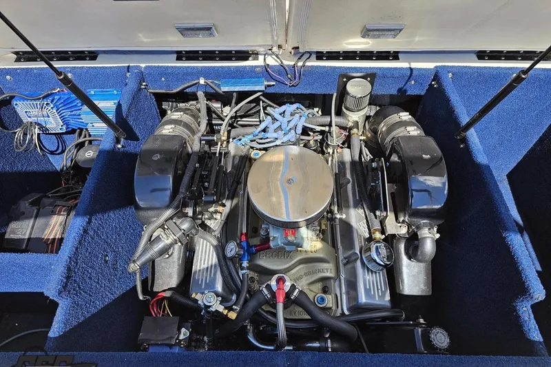 Slide: The Image of Engine compartment of a 1988 Glastron/Carlson CVX-23 boat, showcasing detailed components. - 80