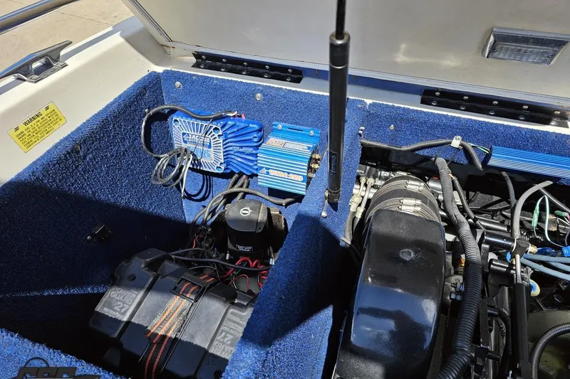 Slide: The Image of 1988 Glastron/Carlson CVX-23 boat engine compartment with battery and wiring. - 83