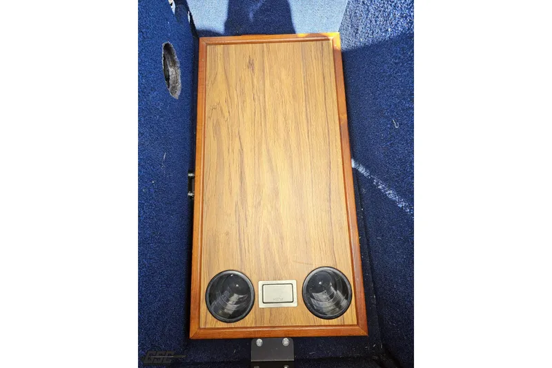 Slide: The Image of 1988 Glastron/Carlson CVX-23 boat interior with wood panel and cup holders. - 84