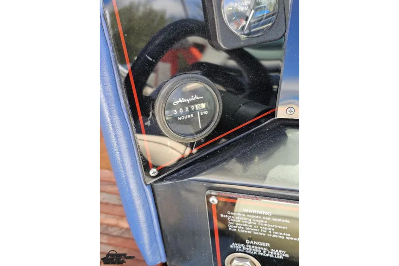 Slide: The Image of 1988 Glastron/Carlson CVX-23 dashboard with hour meter and warning labels. - 85