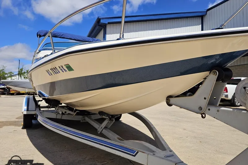 Slide: The Image of 1988 Glastron/Carlson CVX-23 boat on trailer, parked outdoors under blue sky. - 9