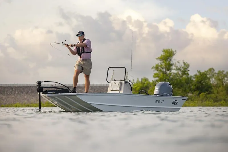 Slide: The Image of Man fishing on a 2026 G3 Bay 17 boat in a scenic water setting. - 4