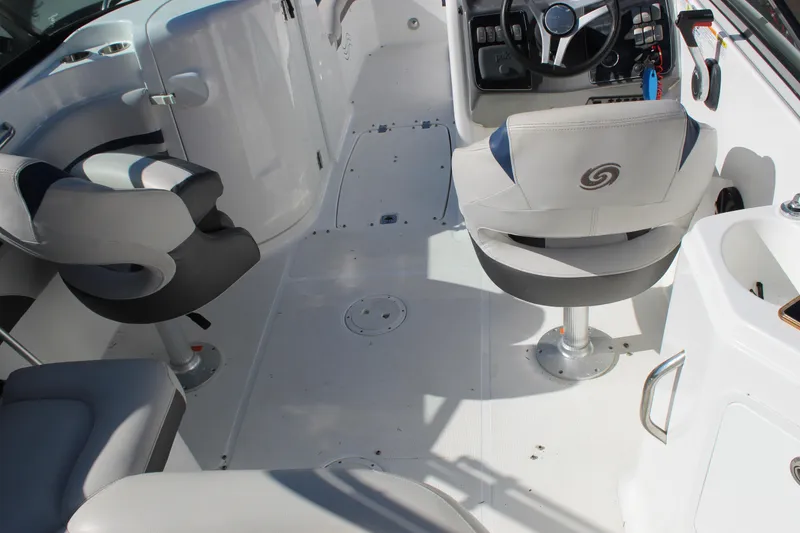 Slide: The Image of 2018 Hurricane SunDeck 2200 DC OB boat interior with steering wheel and seating. - 13