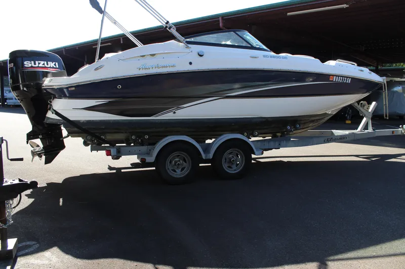 Slide: The Image of 2018 Hurricane SunDeck 2200 DC OB boat on trailer with Suzuki outboard motor. - 14
