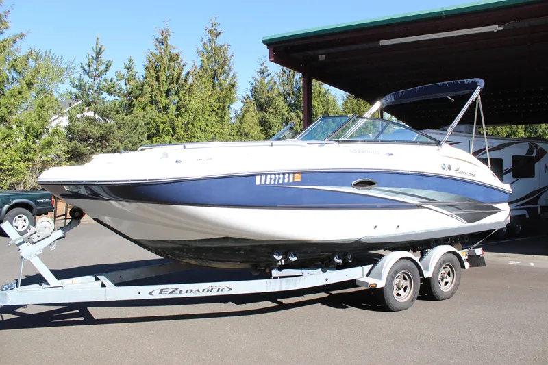 Slide: The Image of 2018 Hurricane SunDeck 2200 DC OB boat on trailer, parked outdoors. - 3