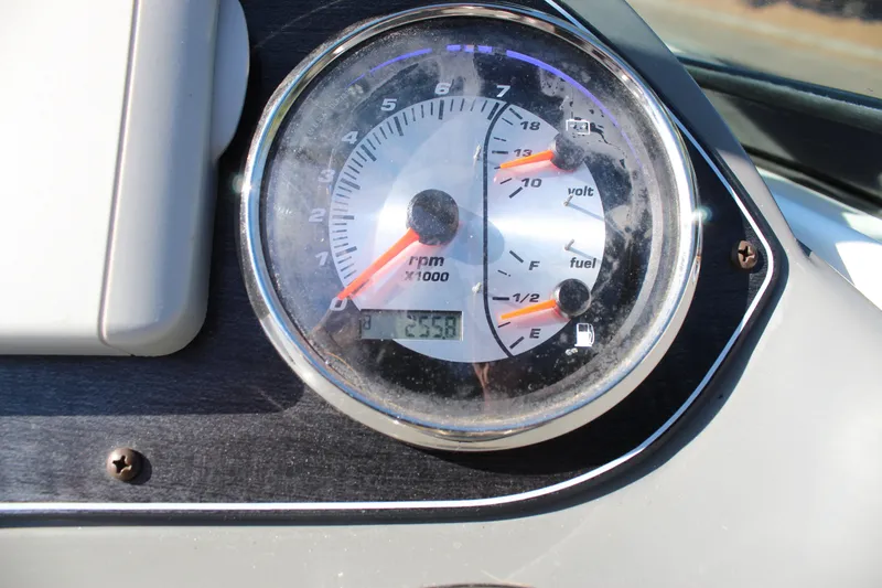 Slide: The Image of Close-up of 2018 Hurricane SunDeck 2200 DC OB dashboard gauge showing RPM, voltage, and fuel levels. - 7