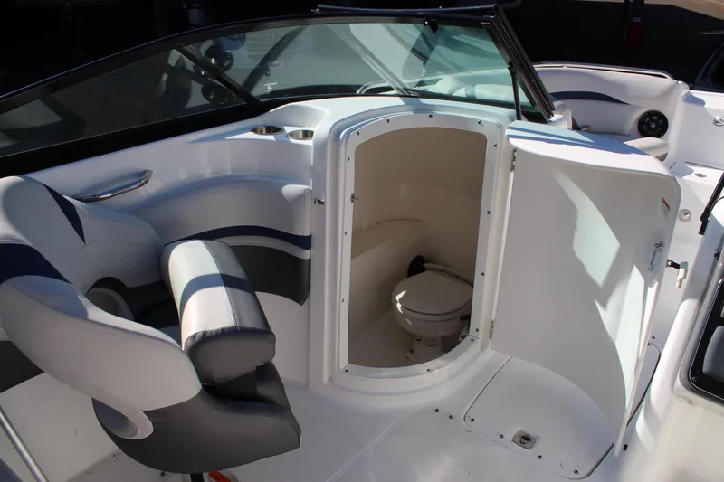 Slide: The Image of 2018 Hurricane SunDeck 2200 DC OB boat interior with open restroom door. - 9