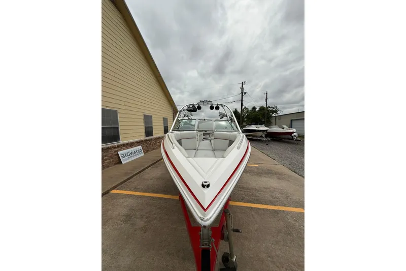 Slide: The Image of 2005 Supra Sunsport 24 V boat parked outdoors on a cloudy day. - 7