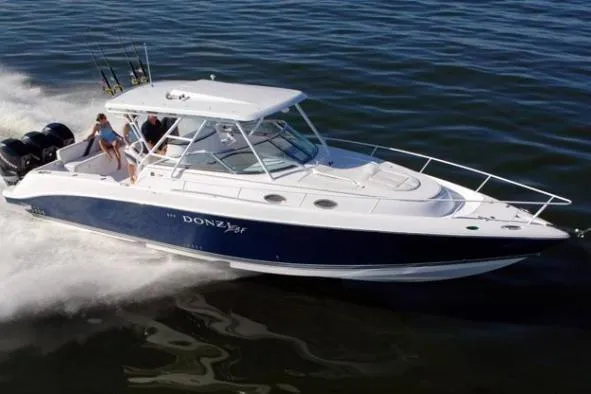 The Image of 2006 Donzi 38 ZSF boat cruising on open water, featuring sleek design and powerful engines. - 0