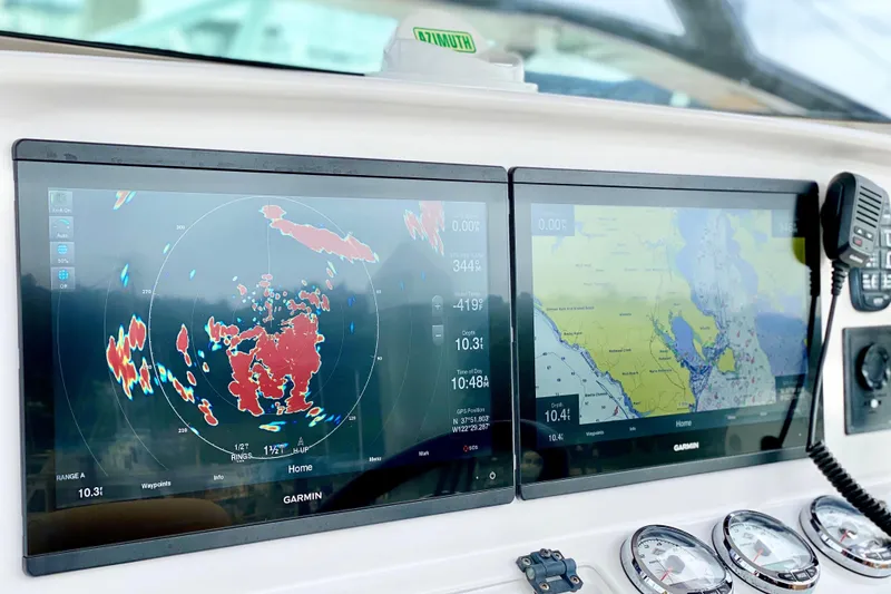 Slide: The Image of Dashboard of a 2006 Donzi 38 ZSF boat with Garmin navigation displays. - 10
