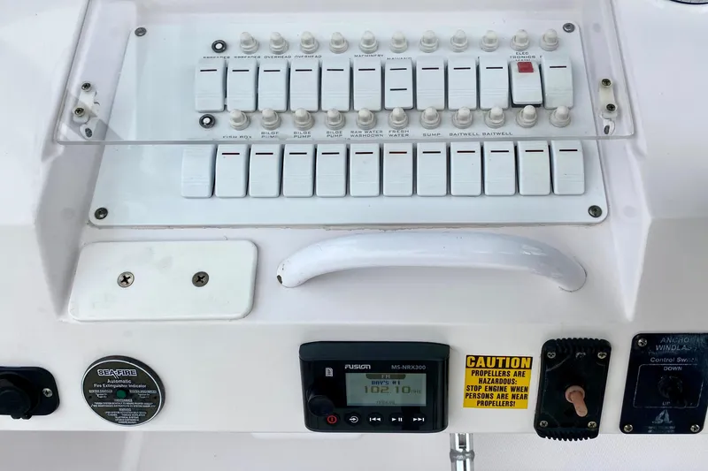 Slide: The Image of Control panel of a 2006 Donzi 38 ZSF boat with switches and caution label. - 13