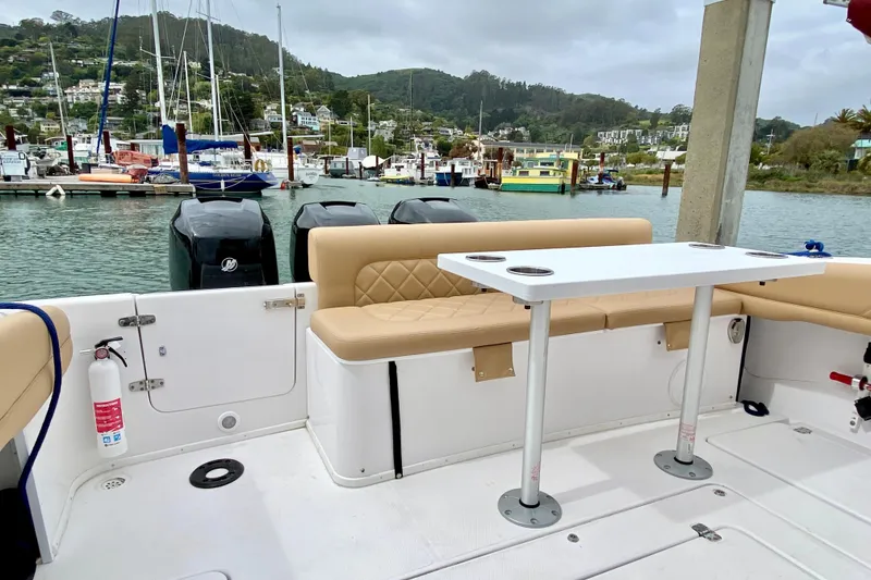 Slide: The Image of 2006 Donzi 38 ZSF boat interior with seating and table, docked at a marina. - 17