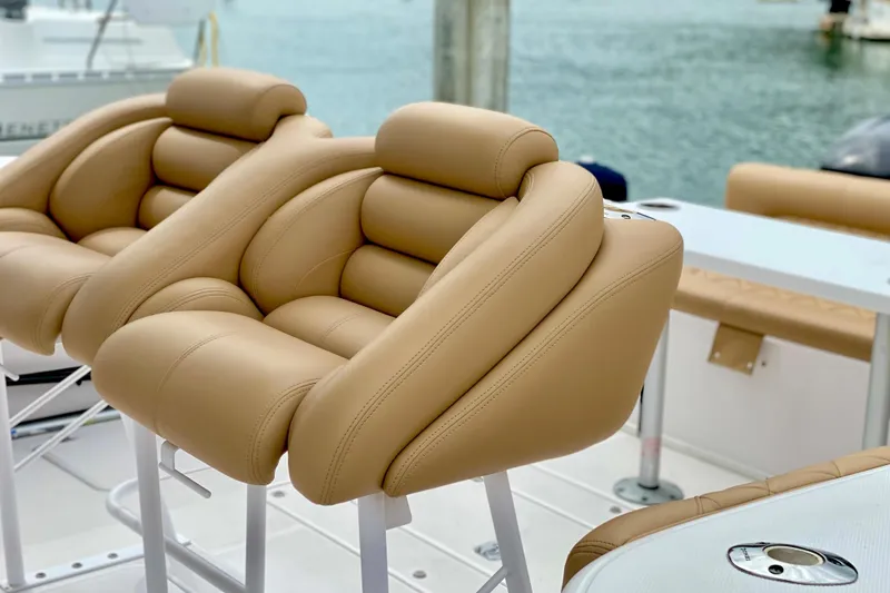 Slide: The Image of Luxurious tan leather seats on a 2006 Donzi 38 ZSF boat, docked by the water. - 18