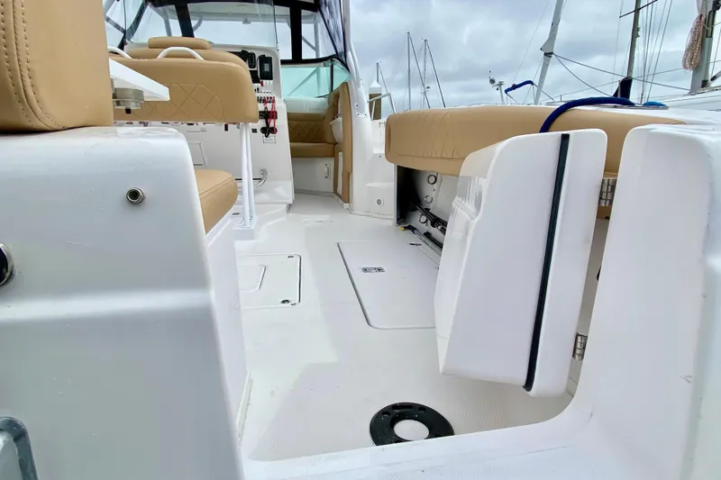 Slide: The Image of 2006 Donzi 38 ZSF boat interior with beige seating and white deck. - 21