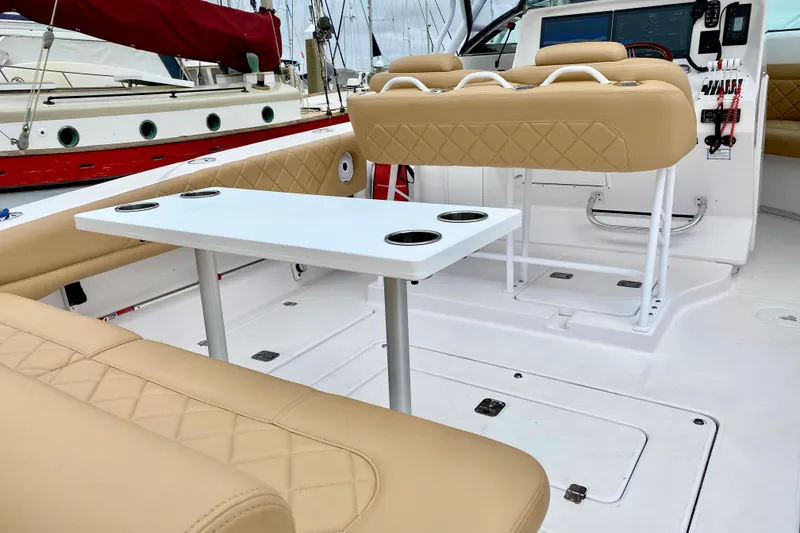 Slide: The Image of 2006 Donzi 38 ZSF boat interior with beige seating and white table. - 25