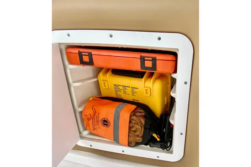 Slide: The Image of Storage compartment on a 2006 Donzi 38 ZSF boat with safety equipment. - 28