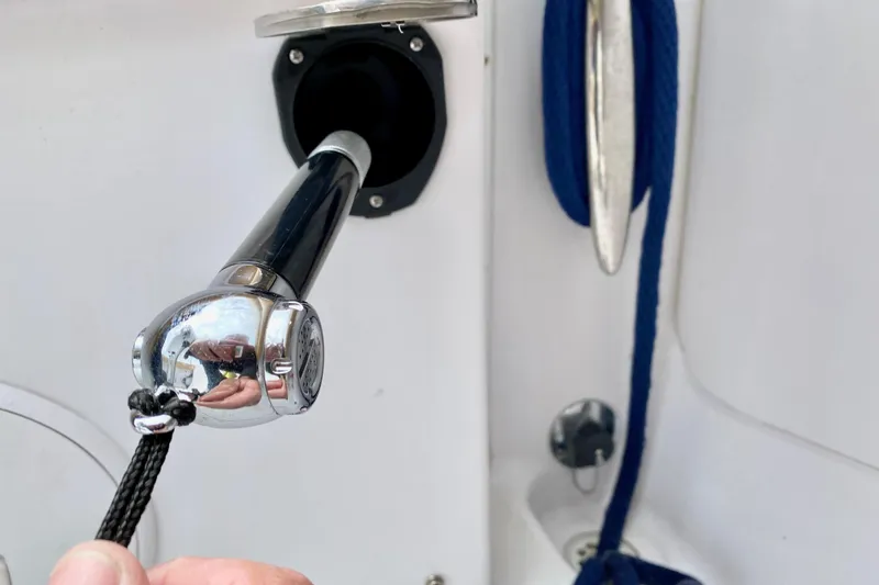 Slide: The Image of Close-up of a 2006 Donzi 38 ZSF boat's chrome shower handle and blue rope. - 29