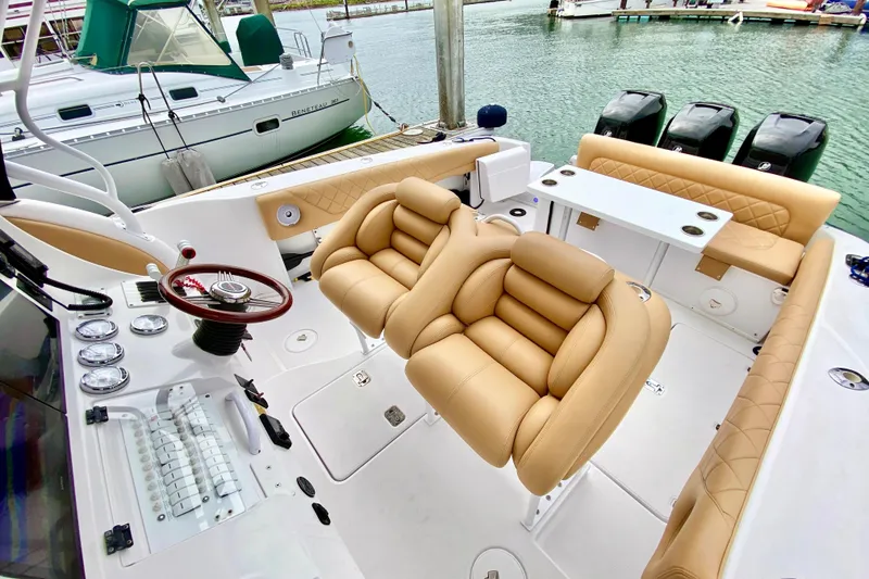 Slide: The Image of 2006 Donzi 38 ZSF boat interior with tan seating and modern dashboard. - 30