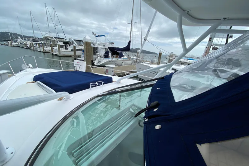 Slide: The Image of 2006 Donzi 38 ZSF boat docked at a marina under cloudy skies. - 31