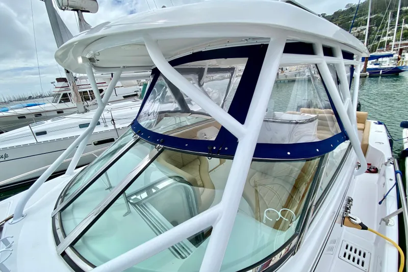 Slide: The Image of 2006 Donzi 38 ZSF boat docked at marina, featuring sleek design and spacious cockpit. - 33