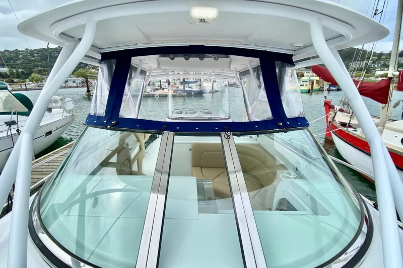 Slide: The Image of 2006 Donzi 38 ZSF boat with sleek windshield and marina backdrop. - 34