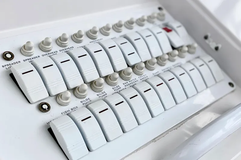 Slide: The Image of Control panel of a 2006 Donzi 38 ZSF boat with labeled switches and toggles. - 36