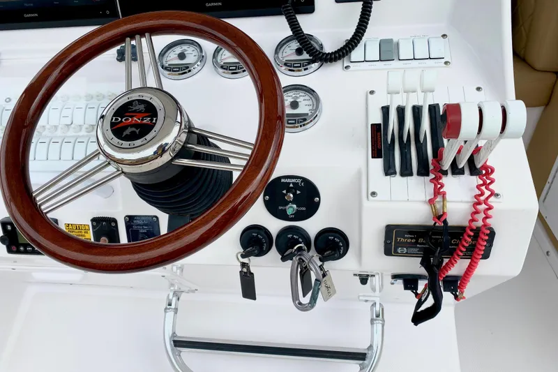 Slide: The Image of Steering wheel and controls of a 2006 Donzi 38 ZSF boat cockpit. - 37