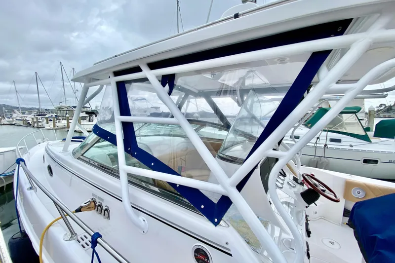 Slide: The Image of 2006 Donzi 38 ZSF boat docked at marina, featuring sleek design and sturdy framework. - 38