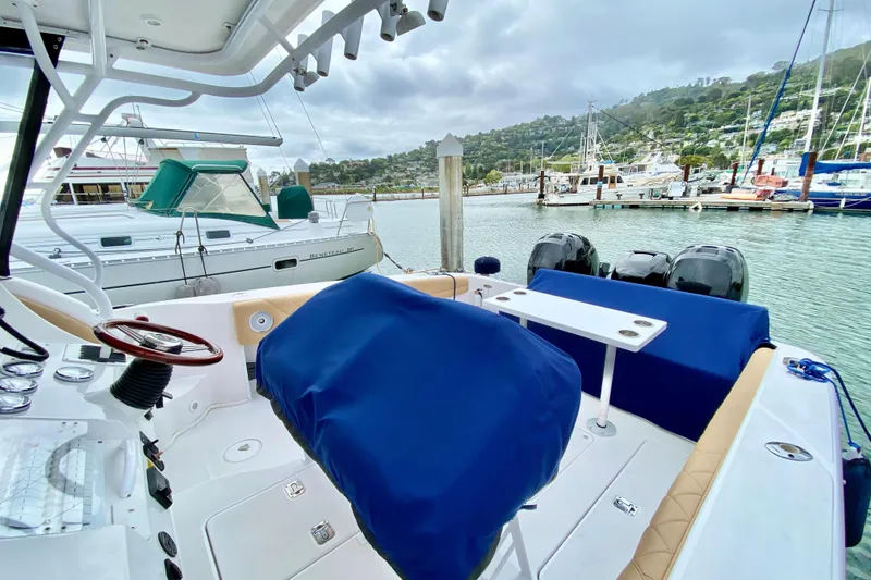 Slide: The Image of 2006 Donzi 38 ZSF boat interior at marina, featuring blue covers and dual engines. - 39