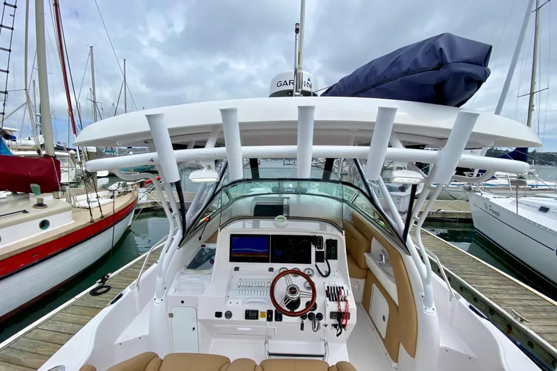 Slide: The Image of 2006 Donzi 38 ZSF boat cockpit with modern controls, docked at marina. - 4