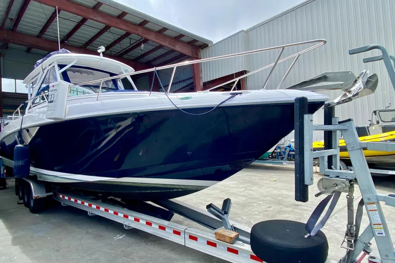 Slide: The Image of 2006 Donzi 38 ZSF boat on trailer in a warehouse setting. - 40