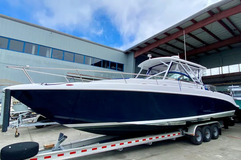 Slide: The Image of 2006 Donzi 38 ZSF boat on trailer in marina, under blue sky. - 41